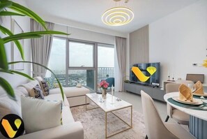 Luxury Apartment, Balcony, City View | Living area | 65-inch Smart TV with cable channels - Vogue | Downtown with Direct Access to Dubai Mall (Dubai)