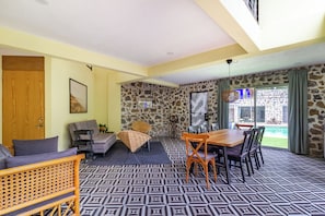 A room with a patterned floor, a dining table with chairs, a sofa, and a wicker chair. - Escape to the countryside: Private House in Boutique Complex. (Tepoztlán)
