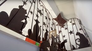 A metal staircase with star and animal cutouts.