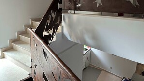 A staircase with a decorative railing featuring white bird silhouettes.