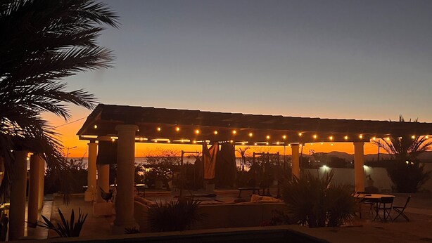 A pool area with lounge chairs and a pergola with string lights. - The Colony La Ventana (La Ventana)