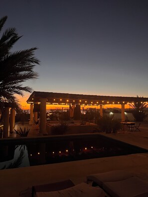 A pool area with lounge chairs and a pergola with string lights. - The Colony La Ventana (La Ventana)