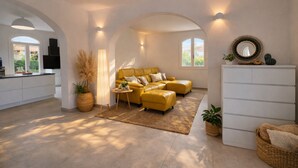 A spacious living area with a yellow sofa, a white cabinet, and a large window. - 🏡 Luxury Villa with Private Saltwater Pool – Porto ColumbuDiscover an exclusive oasis of luxury, privacy and relaxation in Porto Columbu, perfect for guests seeking a refined holiday in a modern and carefully designed villa.The property features a p (Sarroch)