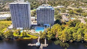 A high-rise hotel with a swimming pool and dock. - Unique Disney & Lake view- 1BD condo (Orlando)