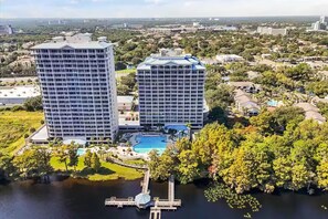 A high-rise hotel with a swimming pool and dock. - Unique Disney & Lake view- 1BD condo (Orlando)
