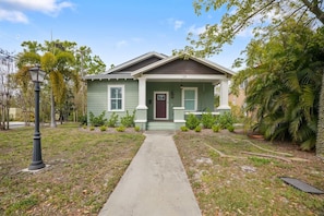 A single-story house with a front porch, a pathway leading to the entrance, and a well-maintained lawn.
