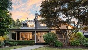 A two-story house with a covered porch, stone exterior, and a well-maintained garden. - SOWDEN HOUSE - Amazing & unique home located less than 20 minutes to down town. (North Vancouver)