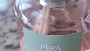 A bottle of Pera Fresca aromatizante on a granite countertop. - New and cozy apartment in exclusive area (Pucon)
