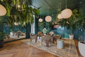 A room with a herringbone floor, wicker furniture, hanging plants, and pendant lighting. - New Luxury Studio Downtown Miami Prime Location (Miami)