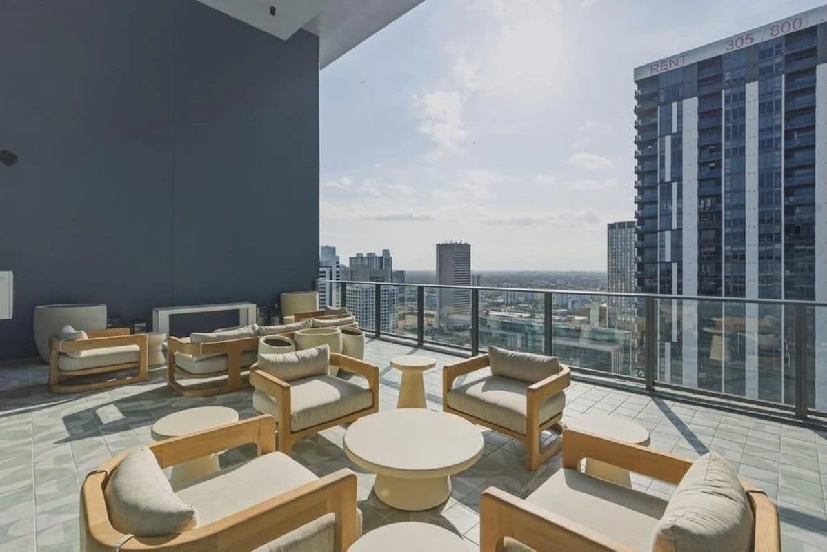 A rooftop lounge with outdoor seating and a city view.