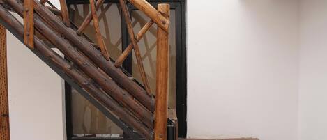 A wooden staircase with a black door frame.