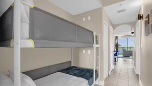 A hotel room with bunk beds, a balcony, and a view of the outdoors. - Trendy lake condo-fireworks view (Orlando)