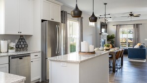 A modern kitchen with white cabinets, stainless steel appliances, and a central island. - Modern Westside Retreat | 5 Min to Blue Ridge Parkway | 15 Min to Biltmore & Downtown Asheville (Fairview)