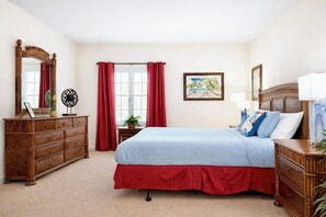 A bedroom with a bed, dresser, and a large mirror. - Holiday Orlando Stay,  Heated Pool & Hot Tub,  Near Disney (Kissimmee)