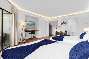 A hotel room with two beds, a desk, a chair, a lamp, and a view of the sea. - Unique & glamorous Universal studio (Orlando)
