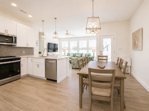 A modern kitchen with white cabinets, a built-in oven, and a dishwasher. - Shared Heated Pool, Pickleball Court, Pet Friendly, Golf Cart Access (Port Aransas)