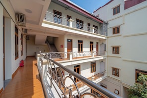 A multi-story residential building with balconies, a staircase, and a fire extinguisher. - Sao Phuong Nam Hotel (Ninh Binh)