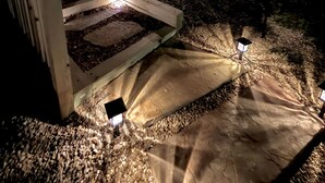 A pathway leading to a house with a porch, surrounded by trees. - Resort Pool, Hot Tub, Firepit & Cornhole (Branson)