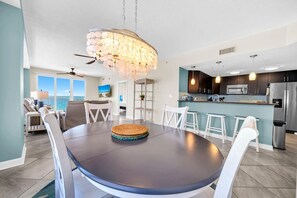 A modern kitchen with dark cabinets, stainless steel appliances, and a large island. - Seychelles 701 (Panama City Beach)