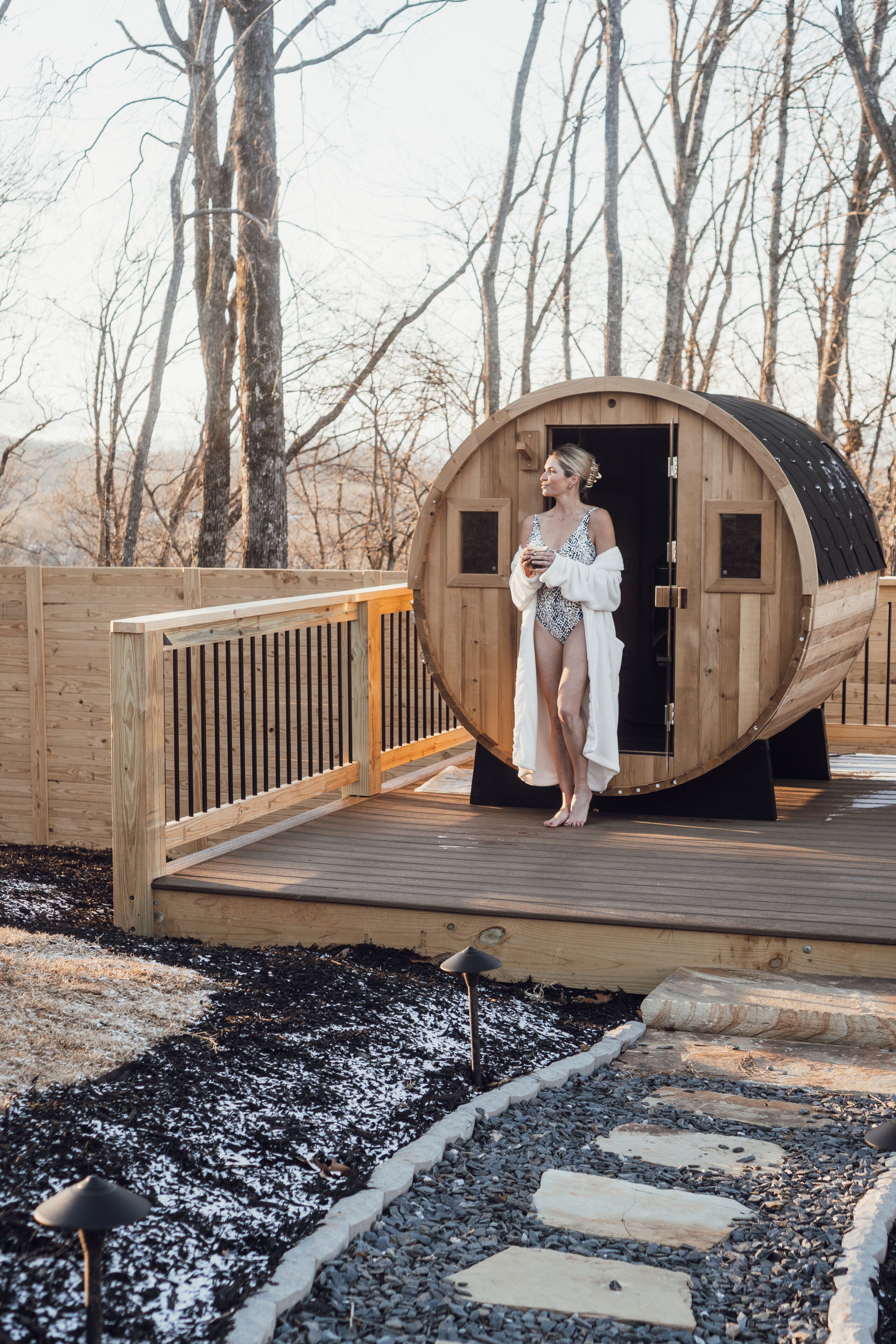 Puurakenteinen sauna, jonka edessä on puinen terassi.