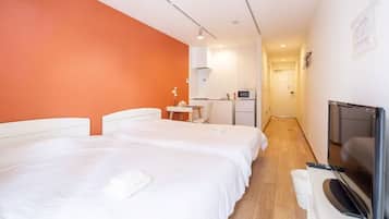 Quadruple Room, Lanai, City View | Desk, laptop workspace, blackout curtains, iron/ironing board