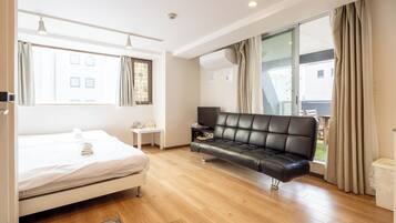 Standard Quadruple Room, Balcony, City View | Desk, laptop workspace, blackout drapes, iron/ironing board