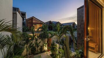 Un moderno resort con varias villas, exuberantes jardines tropicales y una zona de piscina.