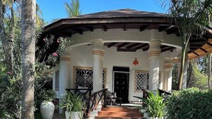A building with a stone-paved entrance, white columns, and a sign reading "LOVE TEMPLE". - African House Resort Malindi (Malindi)