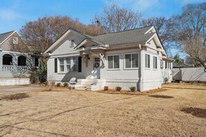 A single-story house with a front porch, a garage, and a well-maintained lawn.
