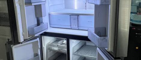 A compact refrigerator with multiple shelves and drawers, likely designed for small spaces.