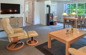 Ein Wohnzimmer mit einer Couch, einem Holzesstisch und einem Kamin.