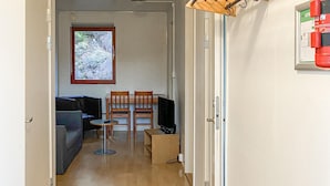 A narrow hallway leading to a living area with a sofa, two chairs, a small table, and a television. - 3 bedroom gorgeous apartment in Myggenäs (Myggenäs)