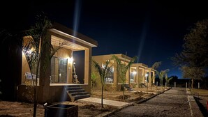 A modern building with a well-lit entrance and steps leading up to the door. - Jalsa Jawai (Bali)