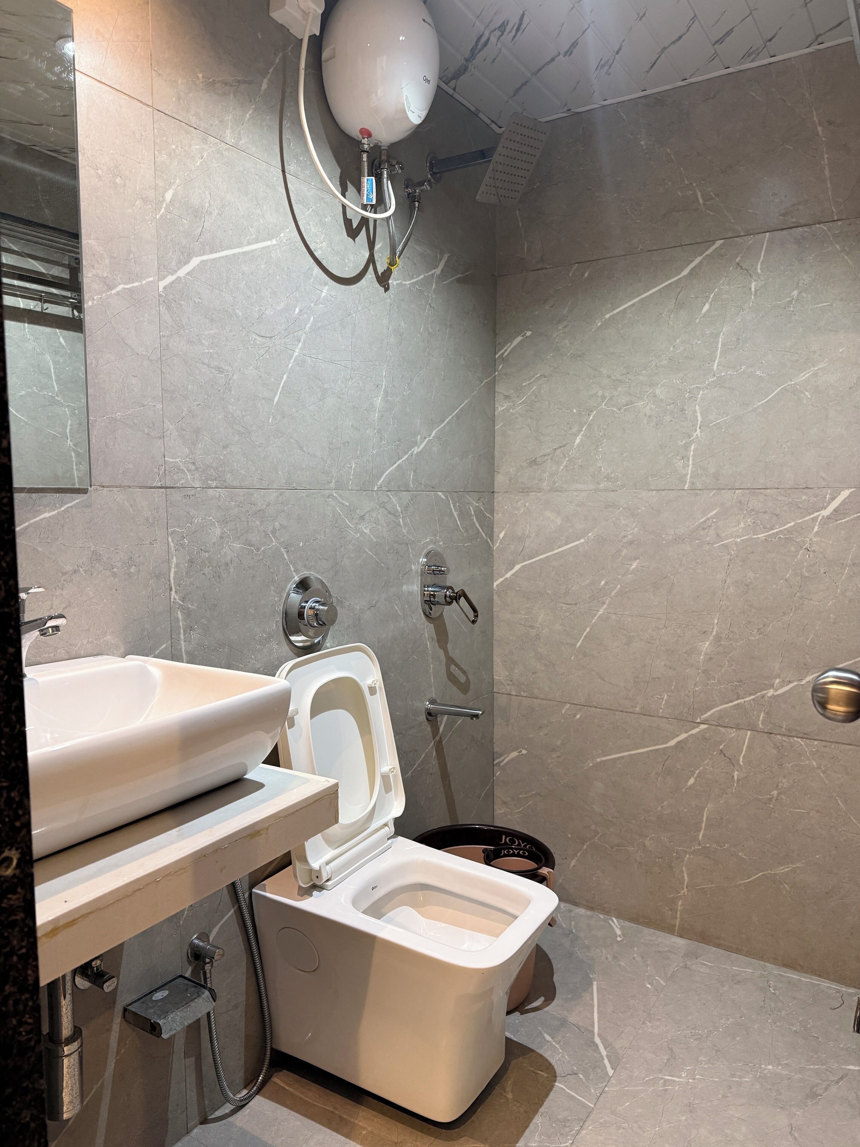 A modern bathroom with a toilet, bidet, and sink.