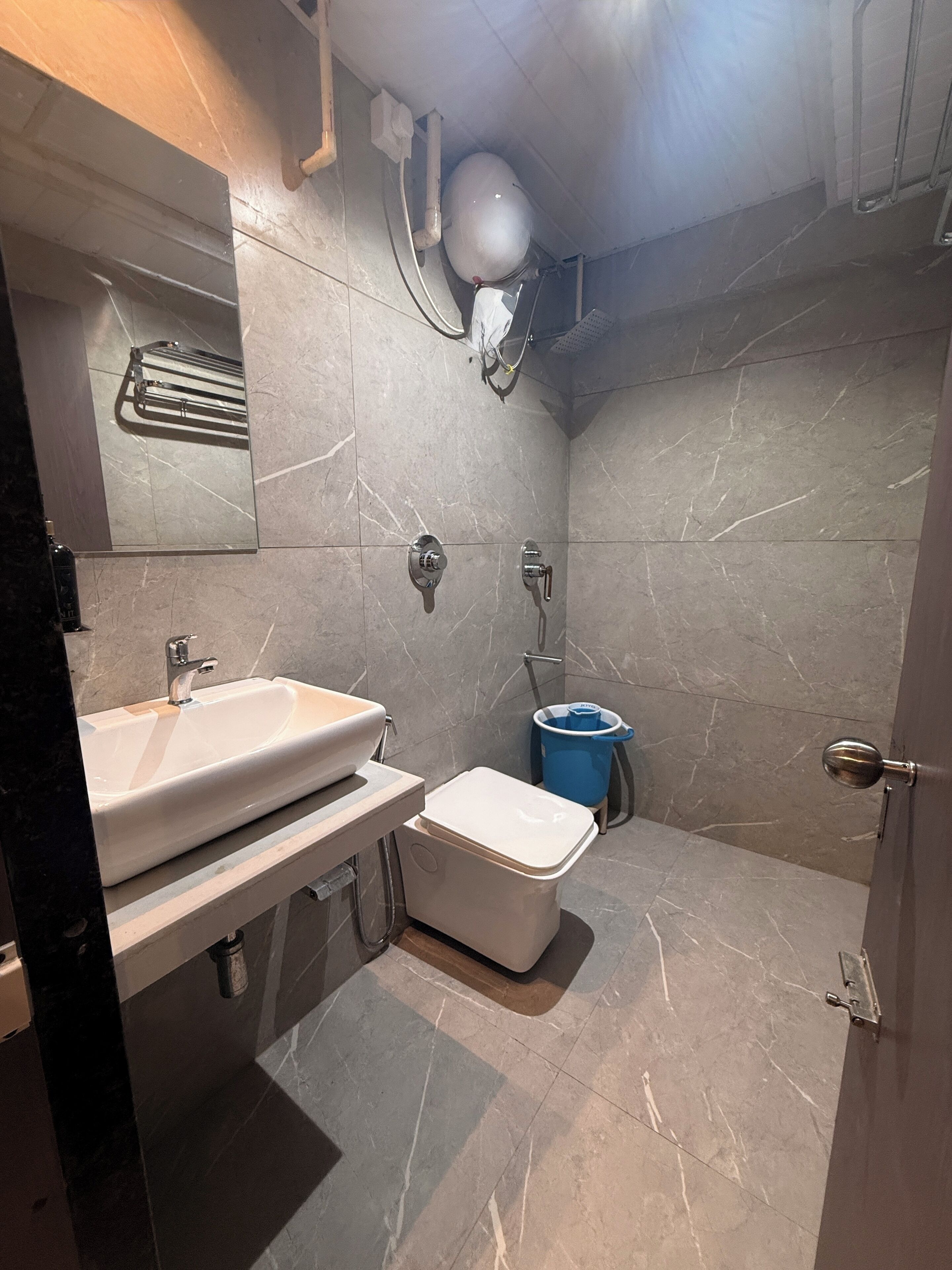 A bathroom with a sink, toilet, and shower.