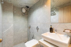 Habitación estándar doble | Baño | Ducha, toallas, jabón y champú