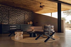 A modern living room with a sofa, coffee table, and chairs.