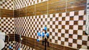 A bathroom with a checkered tile pattern on the walls and a wooden panel design.