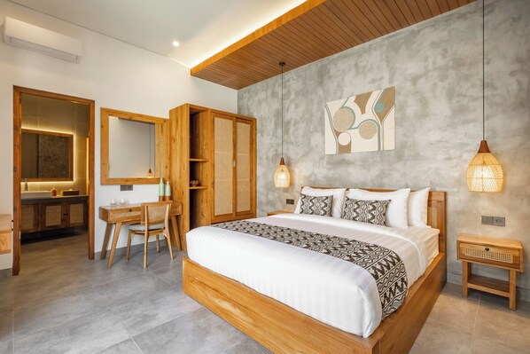 Una camera da letto moderna con un letto grande, una testiera in legno e un'opera d'arte appesa al muro.