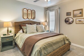 A bedroom with a large bed, two bedside tables, a ceiling fan, and a window with curtains. - Texas A&M Game Day Hub: Family Retreat w/ Yard (Bryan)