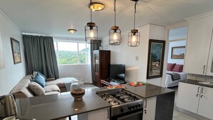 A modern kitchen with a central island, stainless steel appliances, and pendant lighting. - 458 on Manitoba (Pretoria)