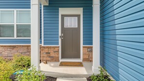 A house with a front door, a porch, and a brick foundation. - Shuttle to the Beach! Spacious Home in Millville (Millville)