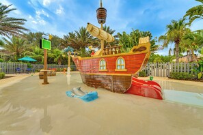 A pirate ship play area with a slide, surrounded by palm trees and a fence. - Theme Park Fun & Resort-Style Perks: Davenport Gem (Davenport)
