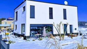 A modern two-story building with a flat roof, large windows, and a satellite dish. - Stylish time-out near Nuremberg/Herzogenaurach (Hagenbüchach)