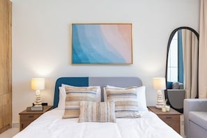 A hotel room with a bed, two bedside tables, a lamp, a painting, and a window with curtains. - Bloomfields Fantastic Stu Maryah (Abu Dhabi)