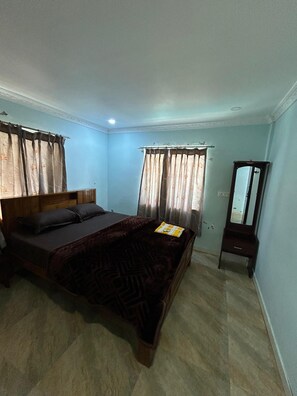 A bedroom with a bed, curtains, a mirror, and a dresser. - 
Peaceful Nature Scenic Views & Private Stay Charming Romantic Private Cottage (Ooty)