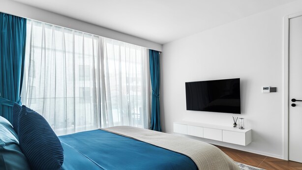 A modern bedroom with a bed, a TV, a white console, and a large window with curtains. - Sunshine by Villacarte (Choeng Thale)
