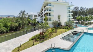 A modern hotel with a pool, a river, and a view of the mountains. - Sunshine by Villacarte (Choeng Thale)