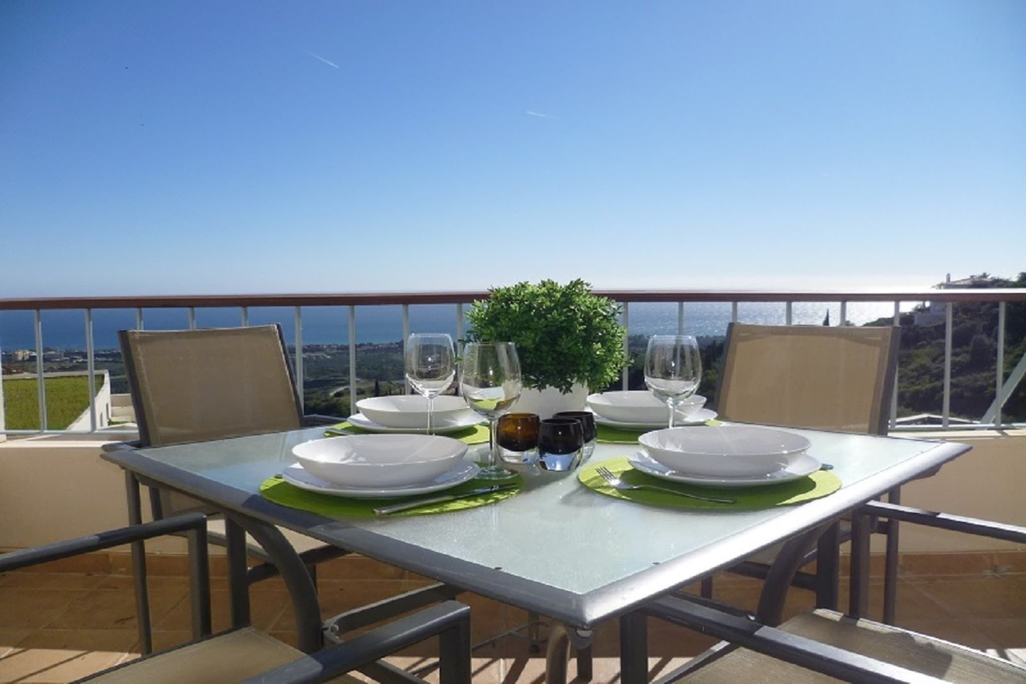 A dining table set for two with a view of the city.