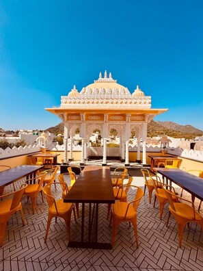 A rooftop terrace with a traditional Indian pavilion and seating area. - Shree ji palace (Udaipur)